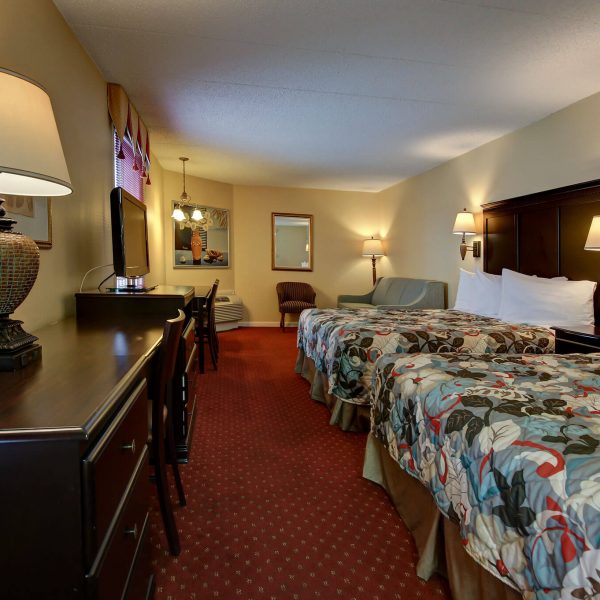 Hotel room with living room and two large beds