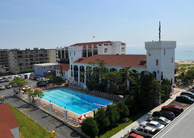 an aerial view of a building with a swimming pool