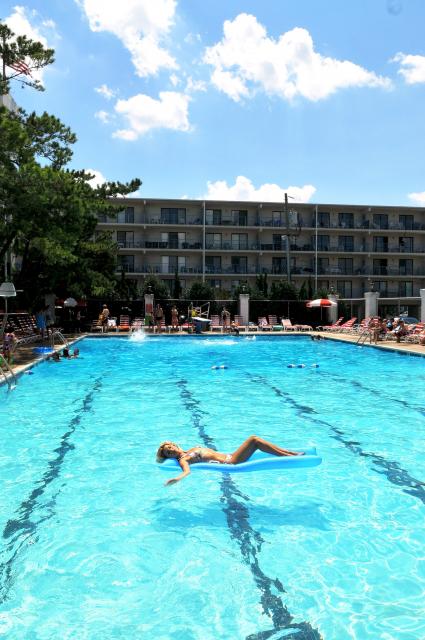 a large swimming pool with people swimming in it