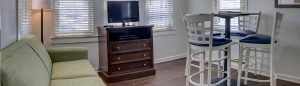 a living room filled with furniture and a flat screen tv