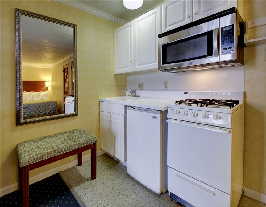 a kitchen with white appliances and a mirror