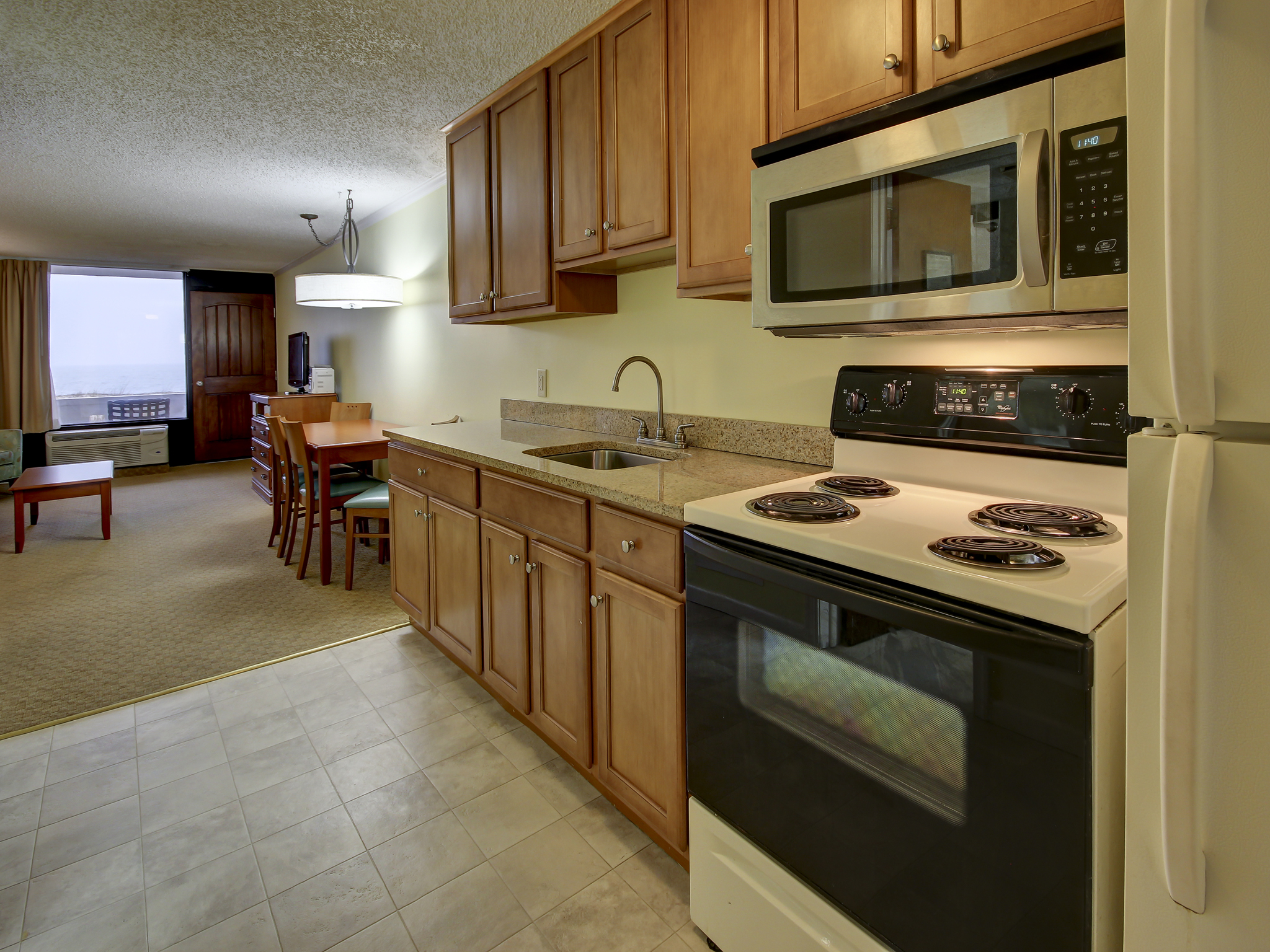 a kitchen with a stove top oven next to a dining room table