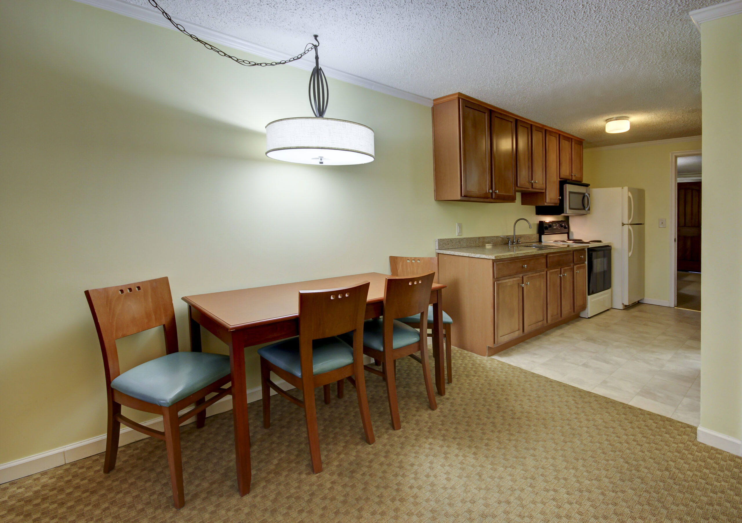 a kitchen and dining room with a table and chairs