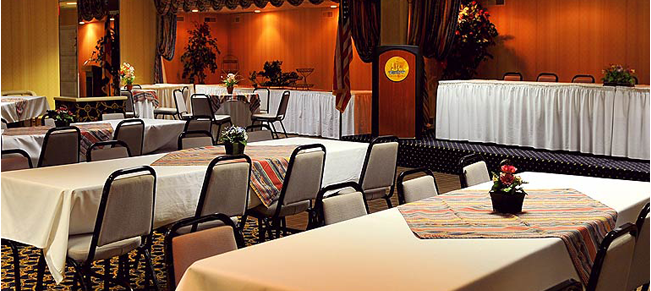 a conference room with tables and chairs and a podium