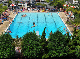 a large swimming pool with people swimming in it