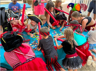 a group of children playing with pirate toys