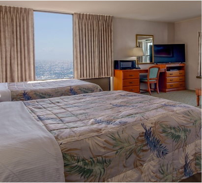 a hotel room with two beds and a television