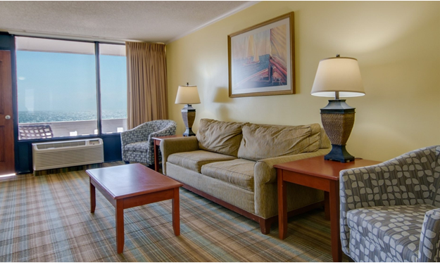 a living room filled with furniture and a large window