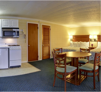 a hotel room with a kitchen and living room