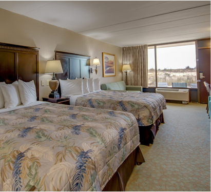 a hotel room with two beds and a desk