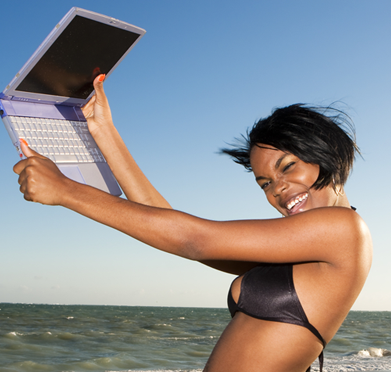 a woman in a bikini holding a laptop computer