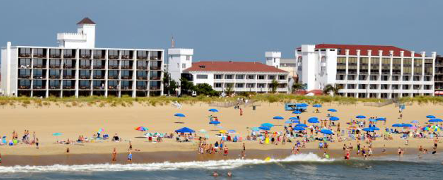 a group of people standing on top of a sandy beach