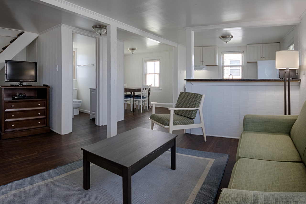 a living room filled with furniture and a flat screen tv