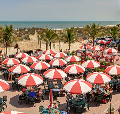 a bunch of red and white umbrellas on a beach