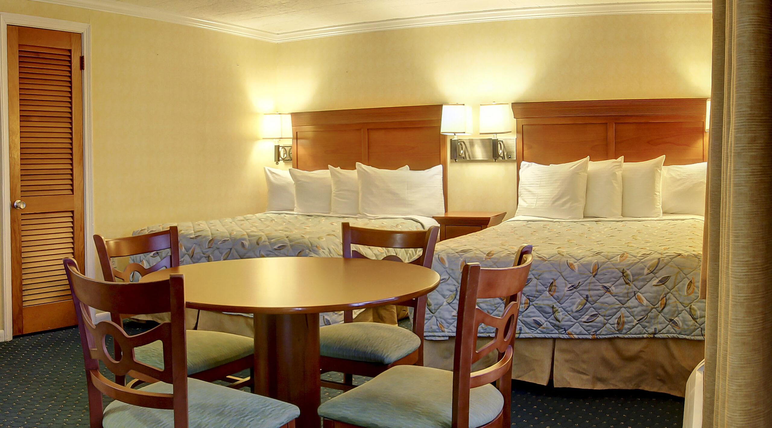 a hotel room with two beds and a table