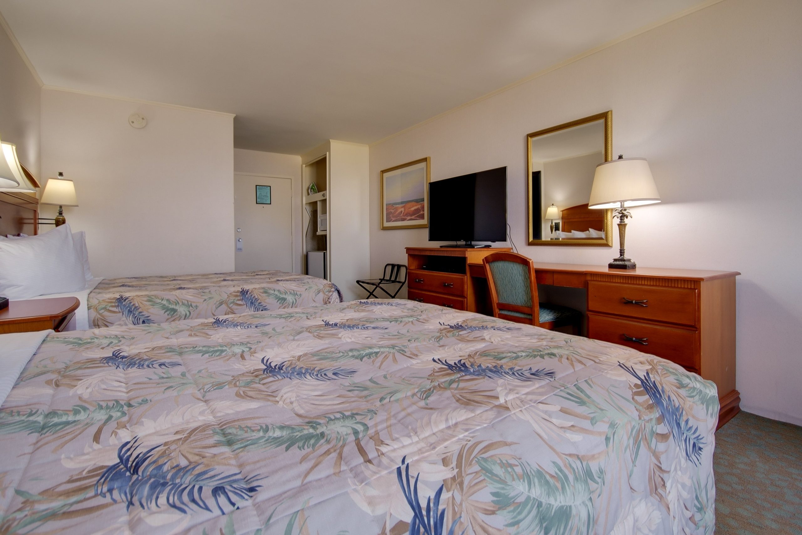 a hotel room with two beds and a television