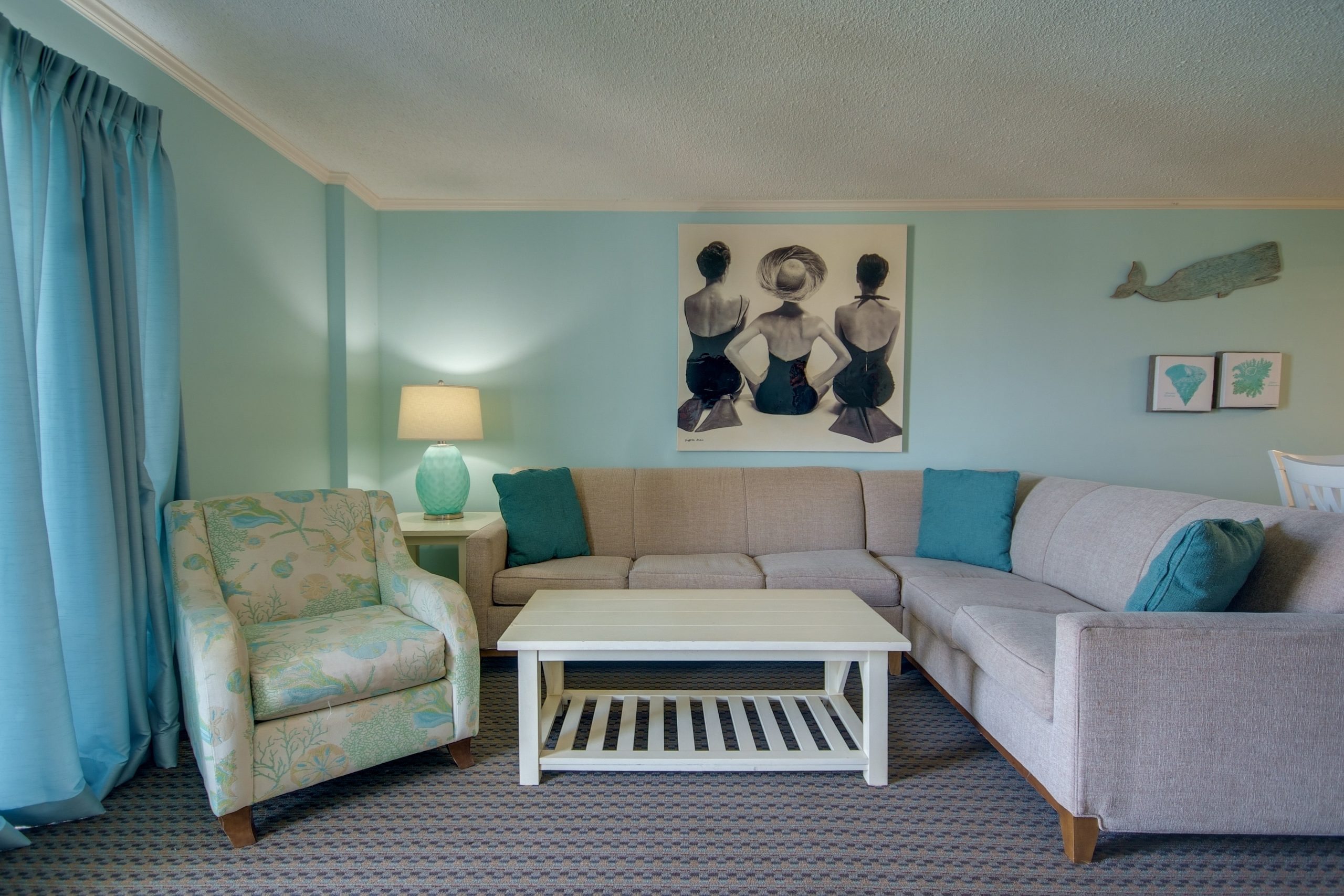 a living room filled with furniture and a painting on the wall