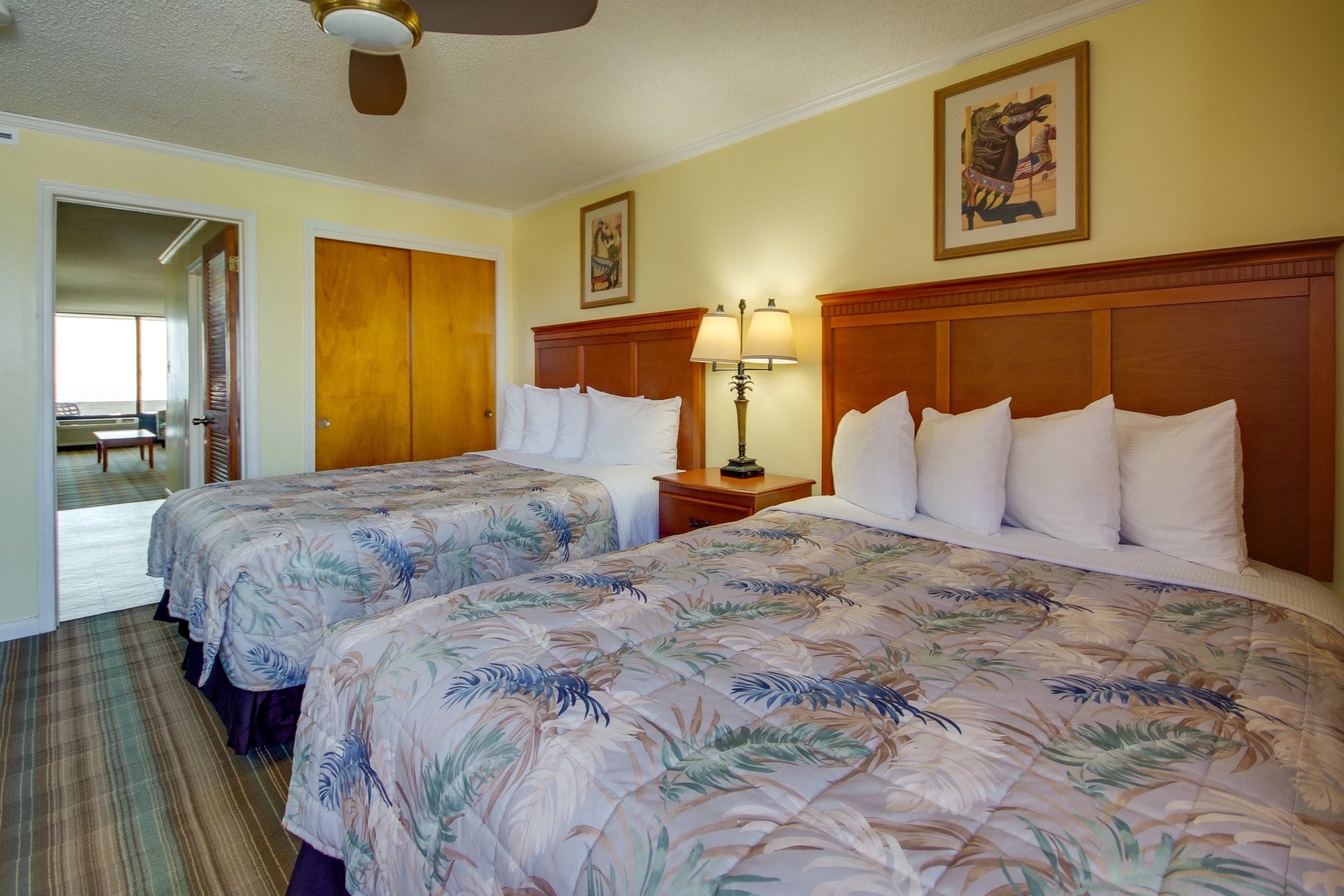 a hotel room with two beds and a ceiling fan