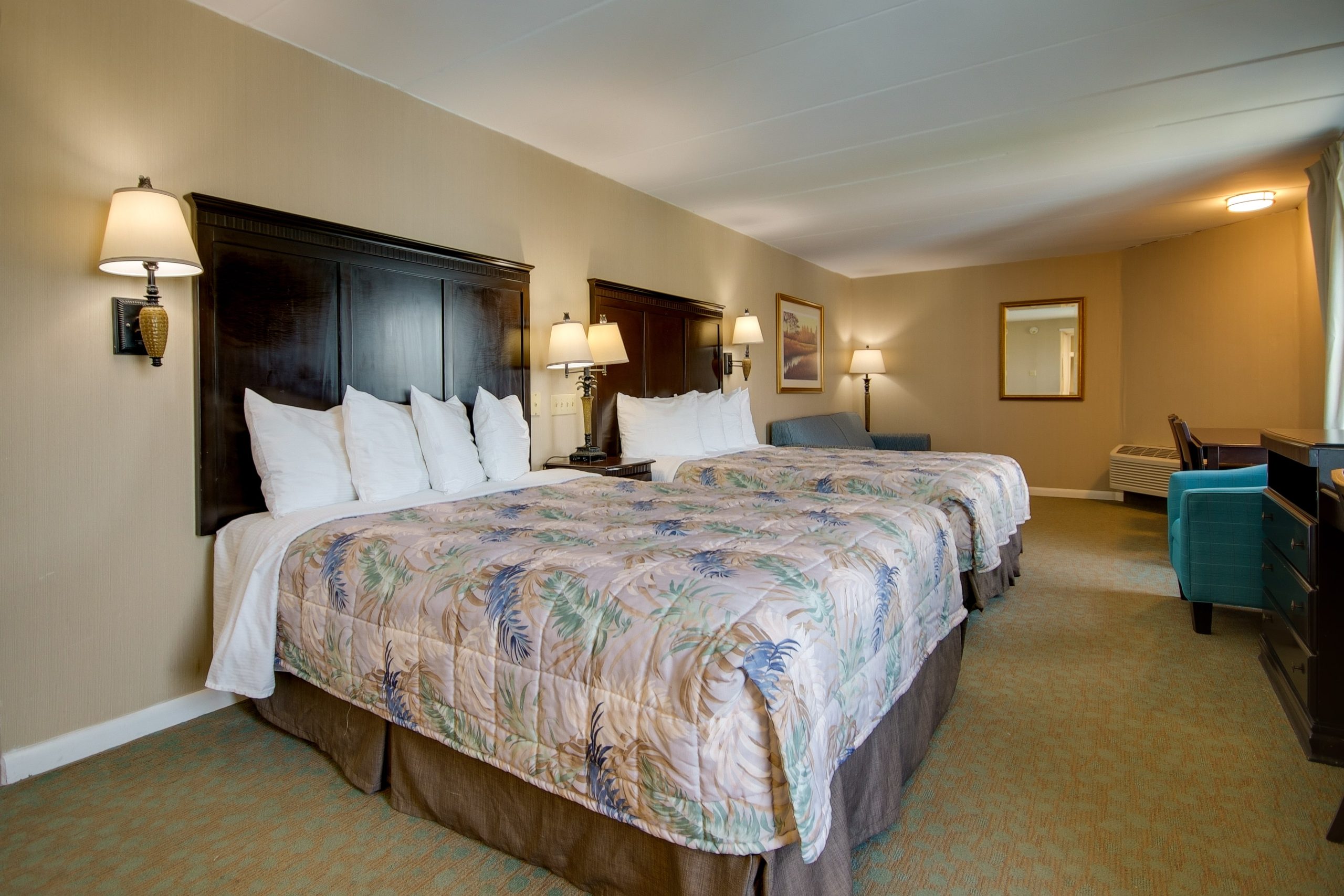 a hotel room with two beds and a desk