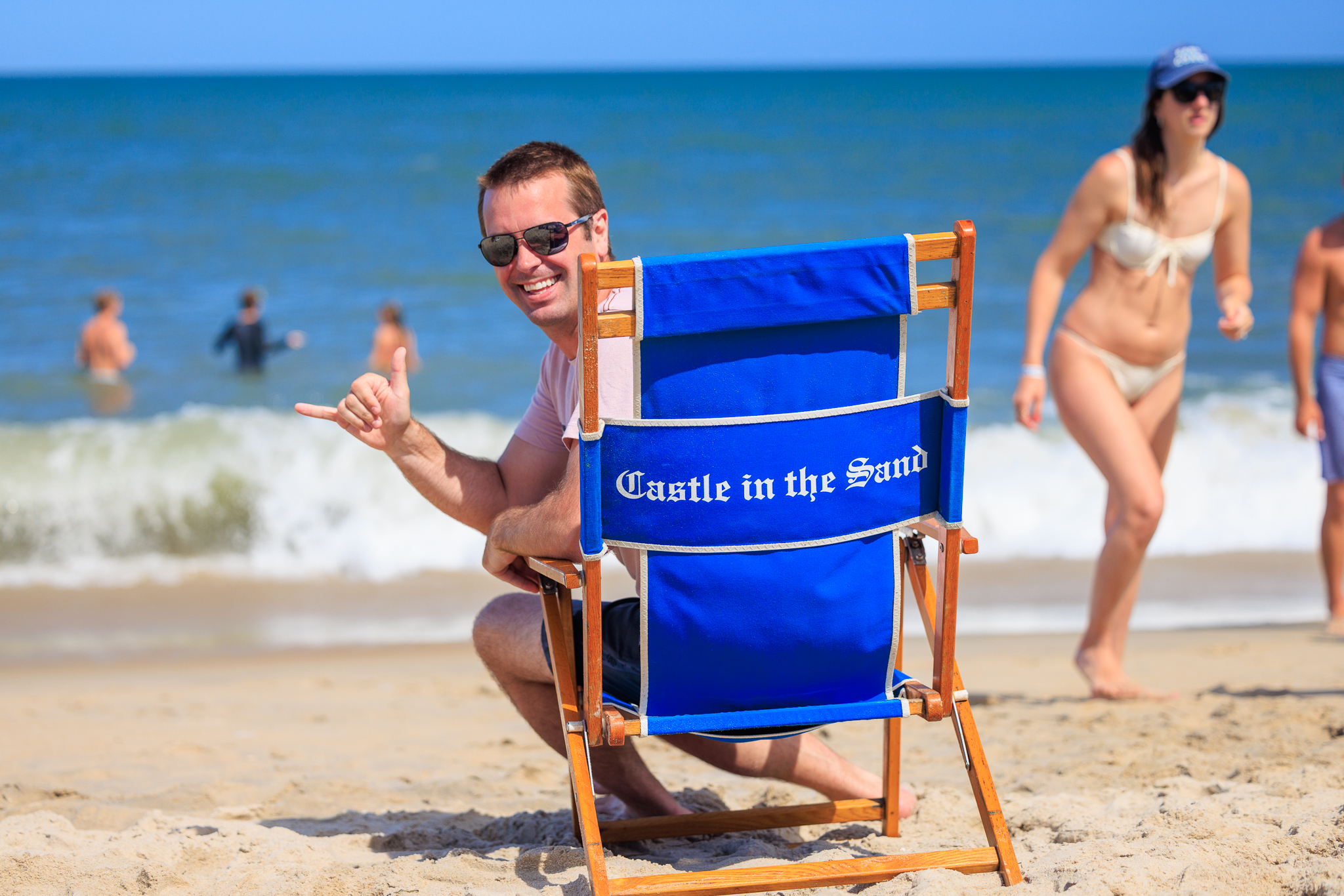 a man sitting in a chair on the beach