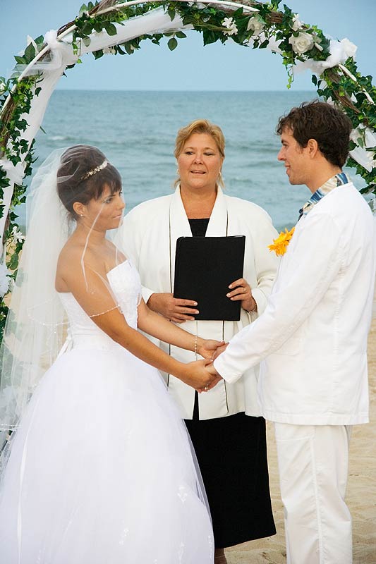 a man and a woman are getting married on the beach