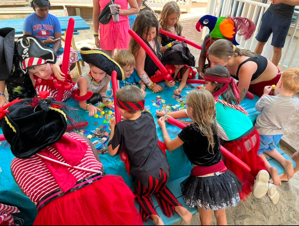 a group of children playing with pirate toys