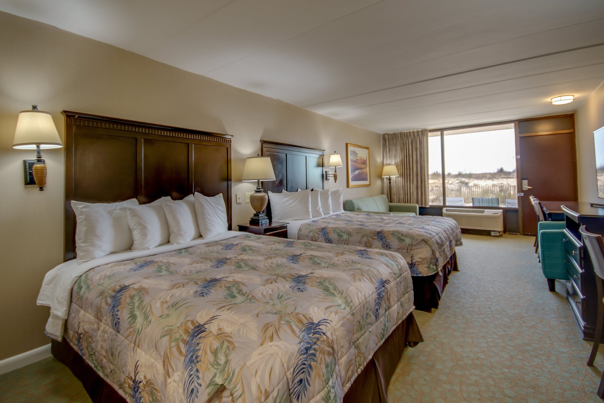 a hotel room with two beds and a desk