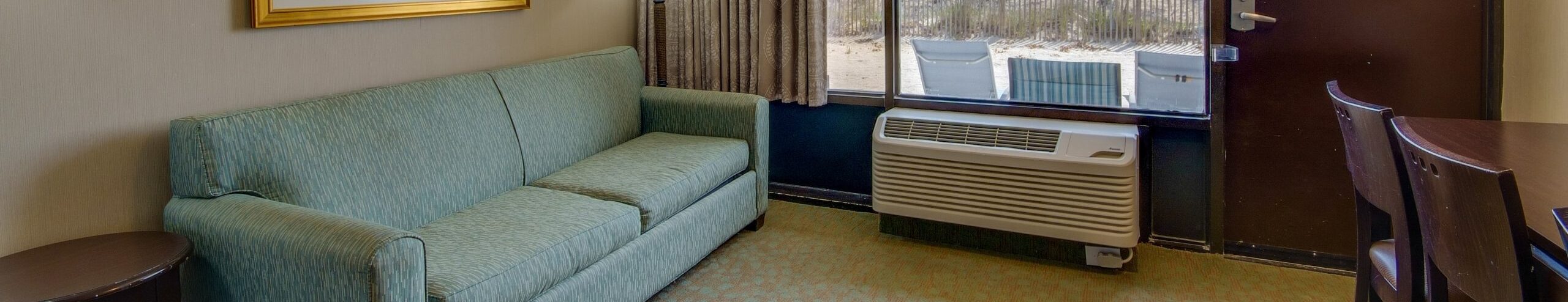 a living room with a couch and a window