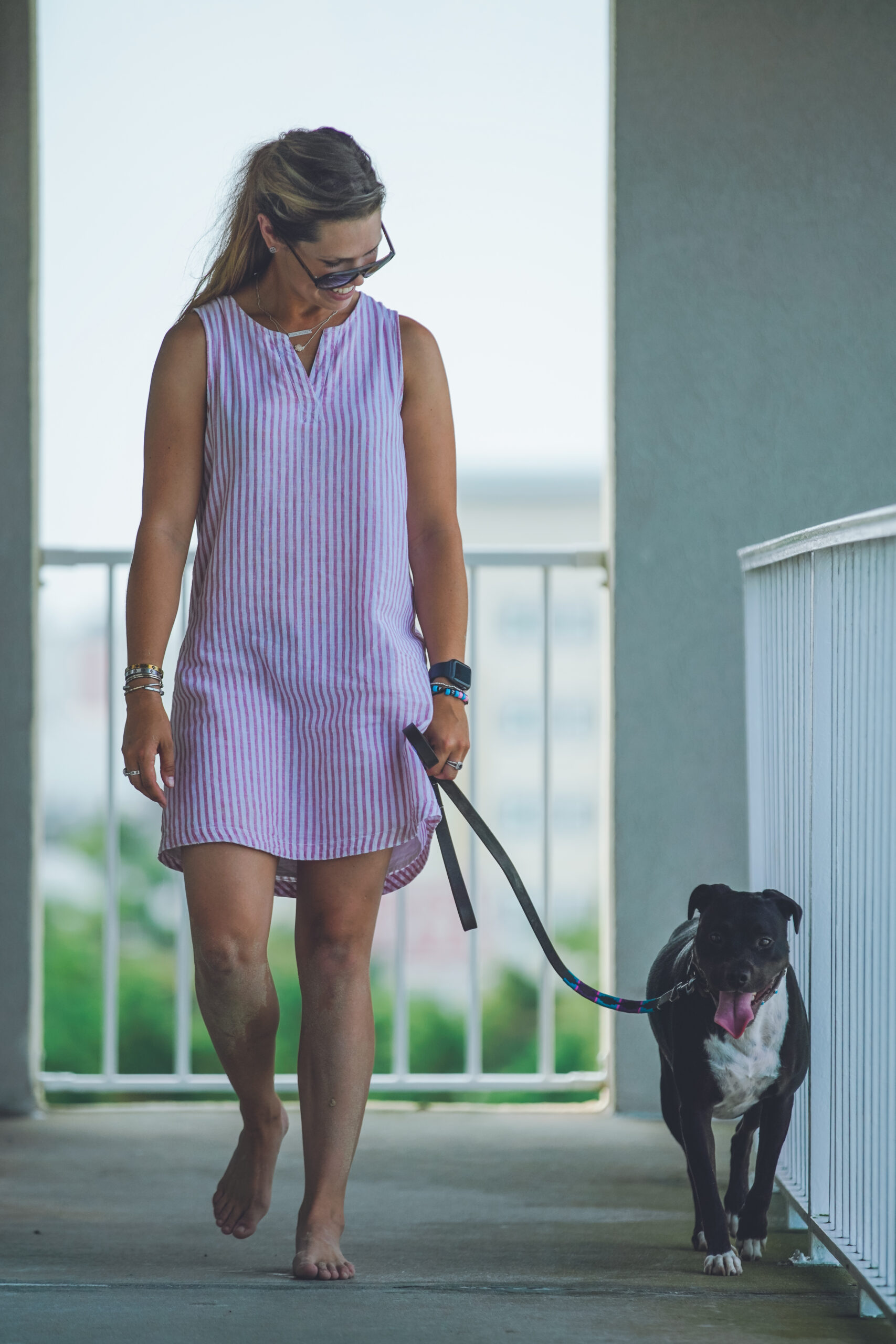 a woman walking a dog on a leash